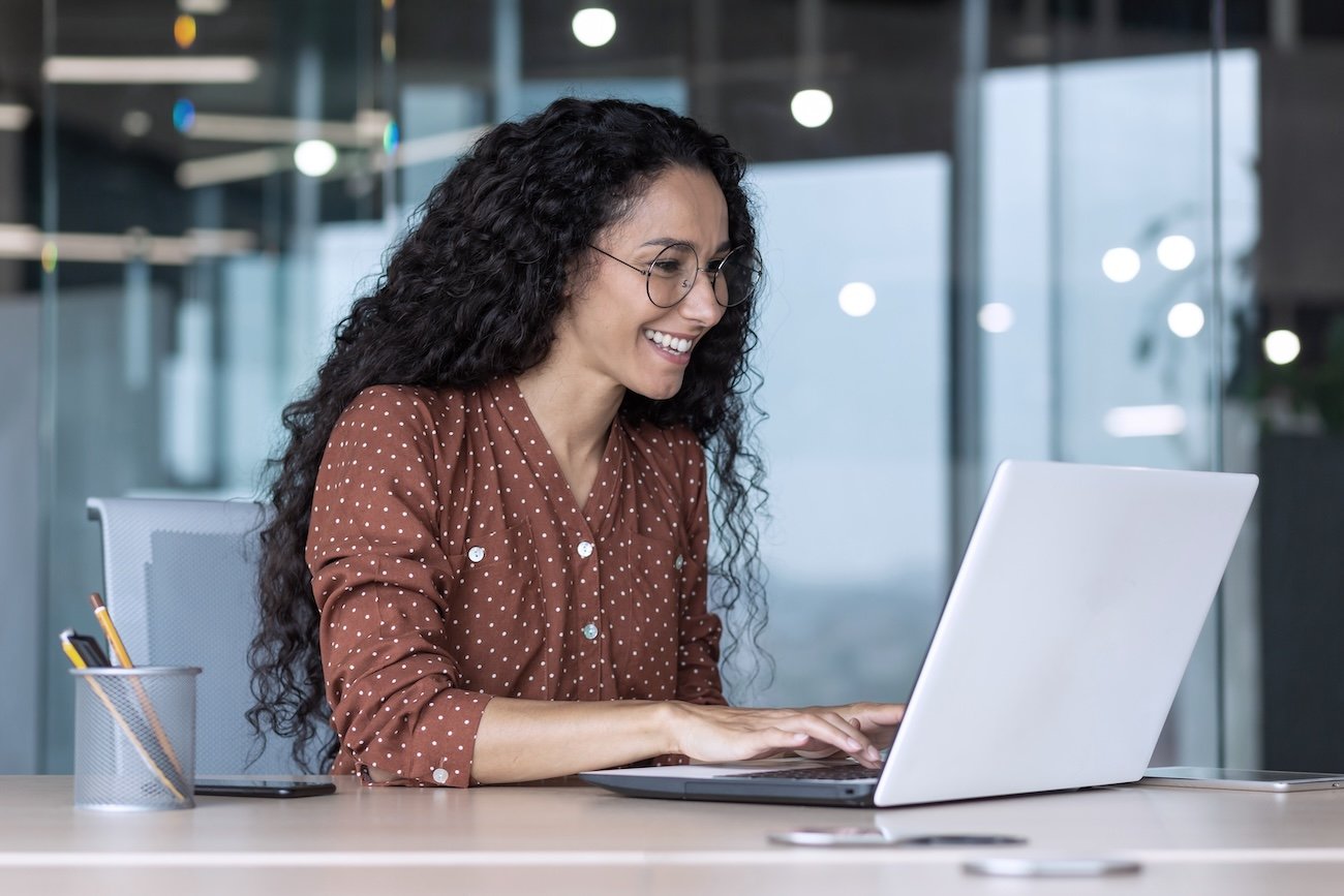 a woman typing on the laptop