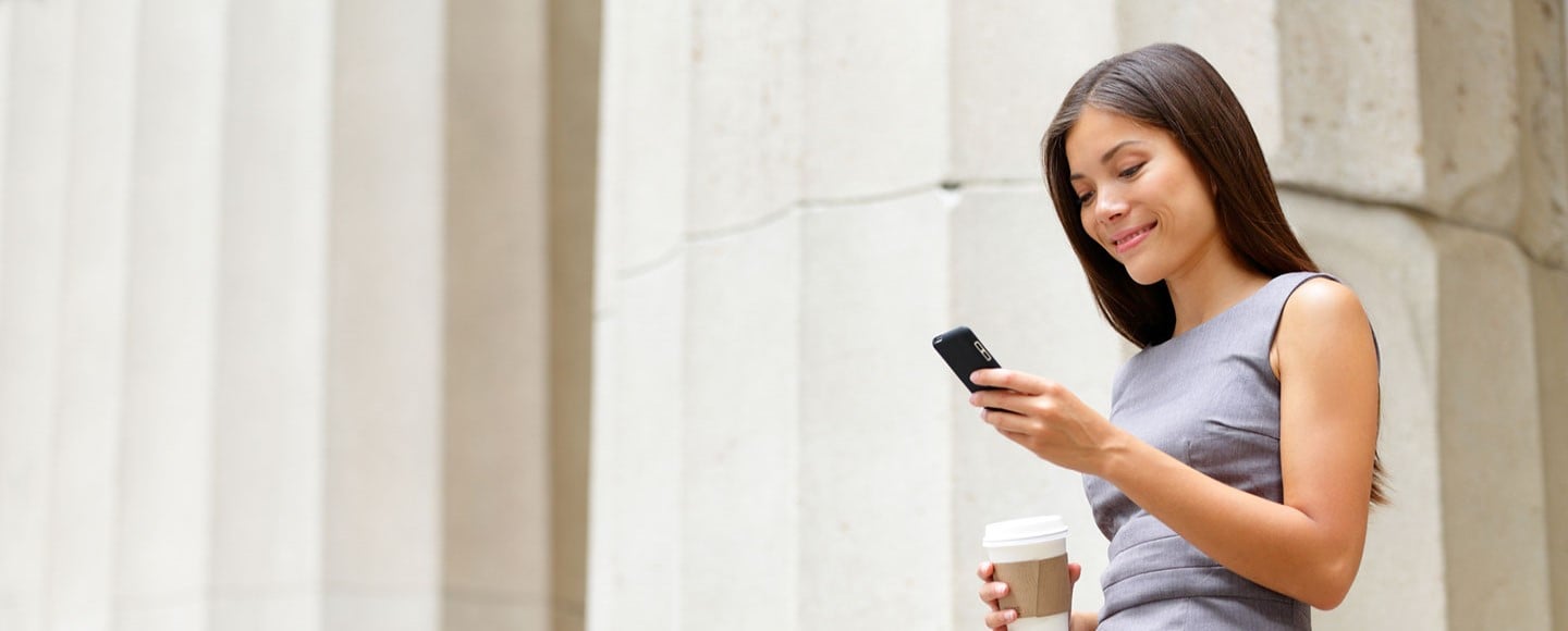 A young business woman reading her phone